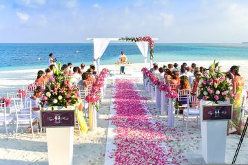 flower strewn wedding aisle on beach